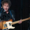 Watch Bob Dylan turn in a rare electric guitar performance as he surprises Farm Aid 2023 with the Heartbreakers backing him